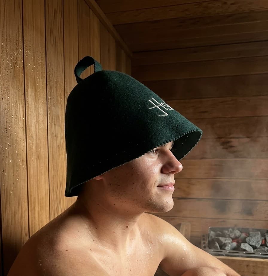 Side view of a Smelt sauna hat worn low over the ears